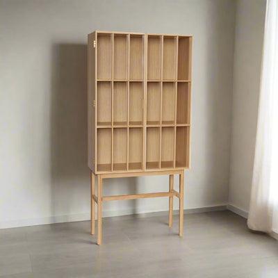 Wooden bookshelf with multiple compartments on a white background